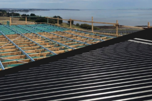 before and after coastal home dark metal roofing